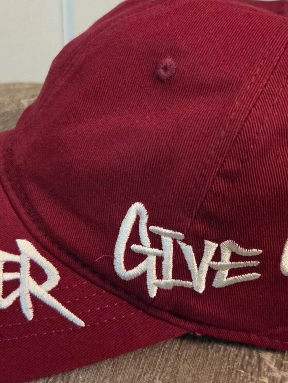 Maroon Baseball Cap with 'Never Give Up' Embroidery
